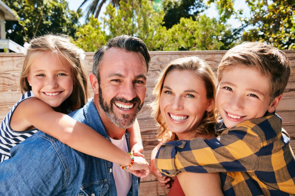 Portrait of a happy young family spending quality time in their backyard at home